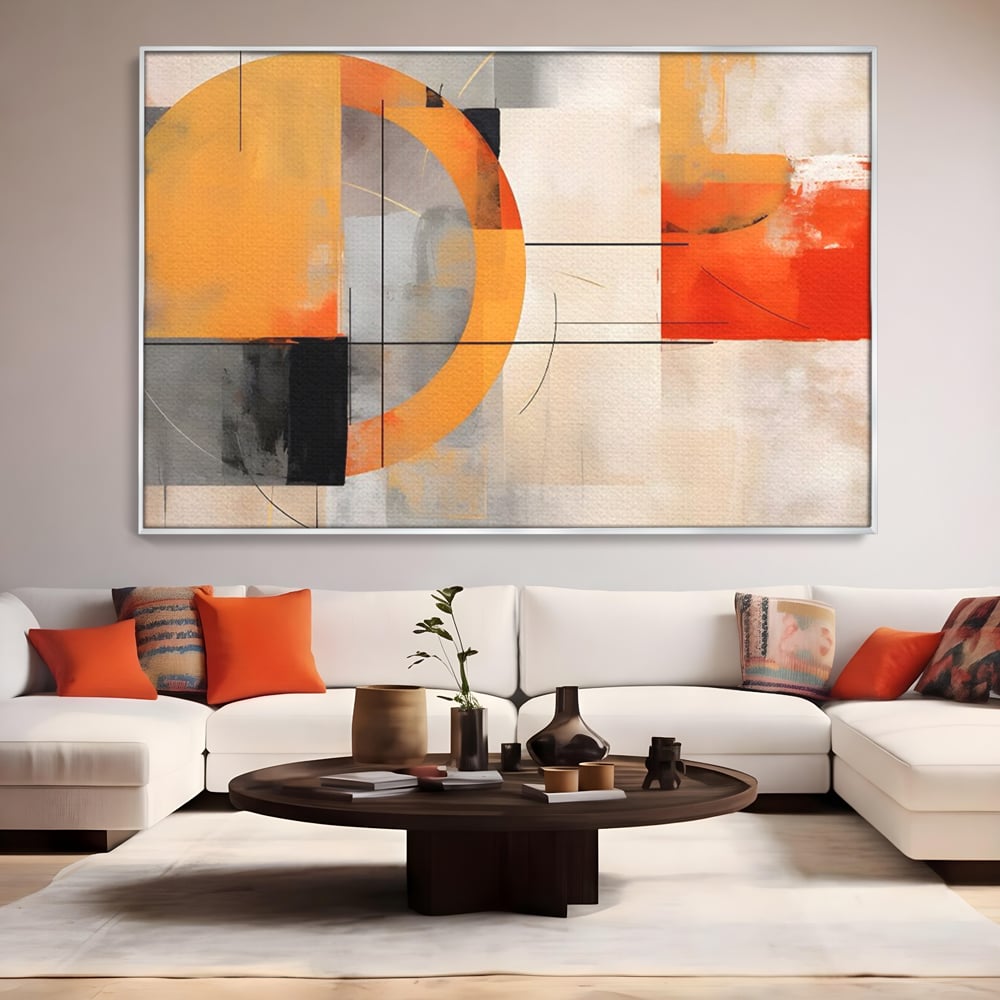 Tablou canvas cu pictura abstracta cu cerc galben, in rama de aluminiu argintiu, pe perete intr-un living